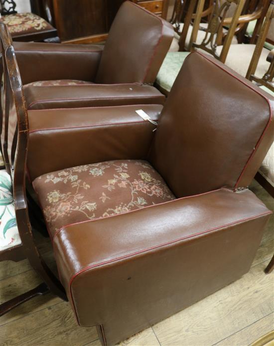 A pair of leather club chairs